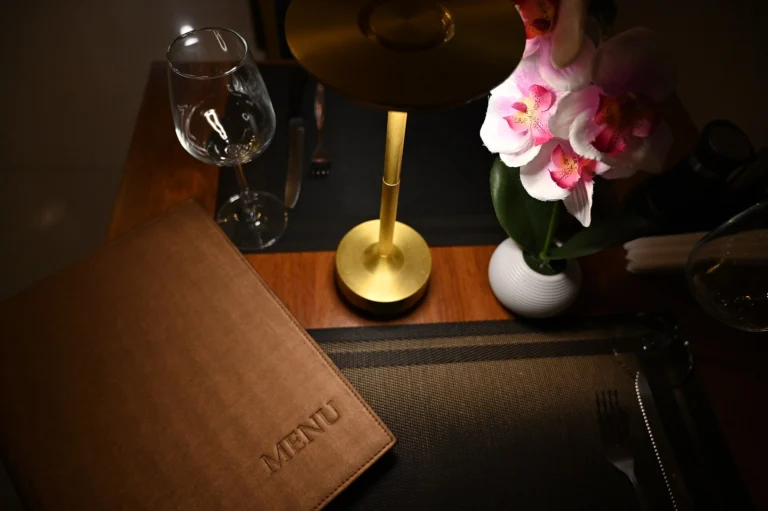 An intimate dinner table for two set with orchids (illustrative image)